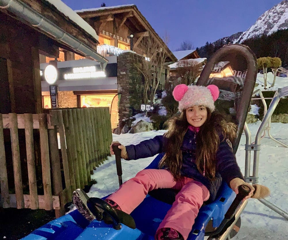 A young girl sitting on alpine coaster in Chamonix.