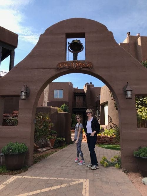 A maom and daughter stand at the entrance to the Adobe Grand Villas Hotel in Sedona