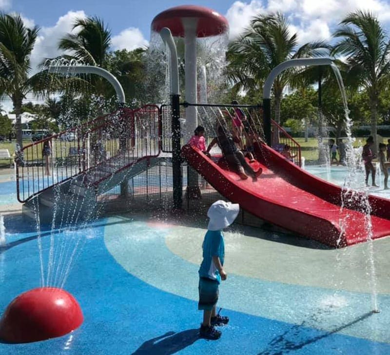 A toddler enjoyes the water and slides at City Park in Key West.