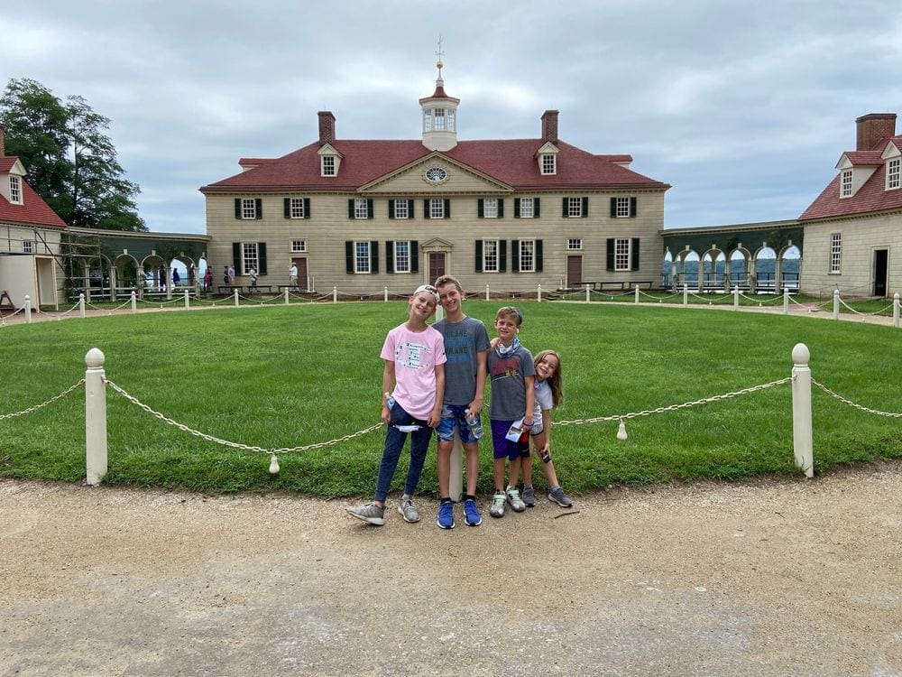 Four kids stand in front of the main house at Mount Vernon near Washington DC.