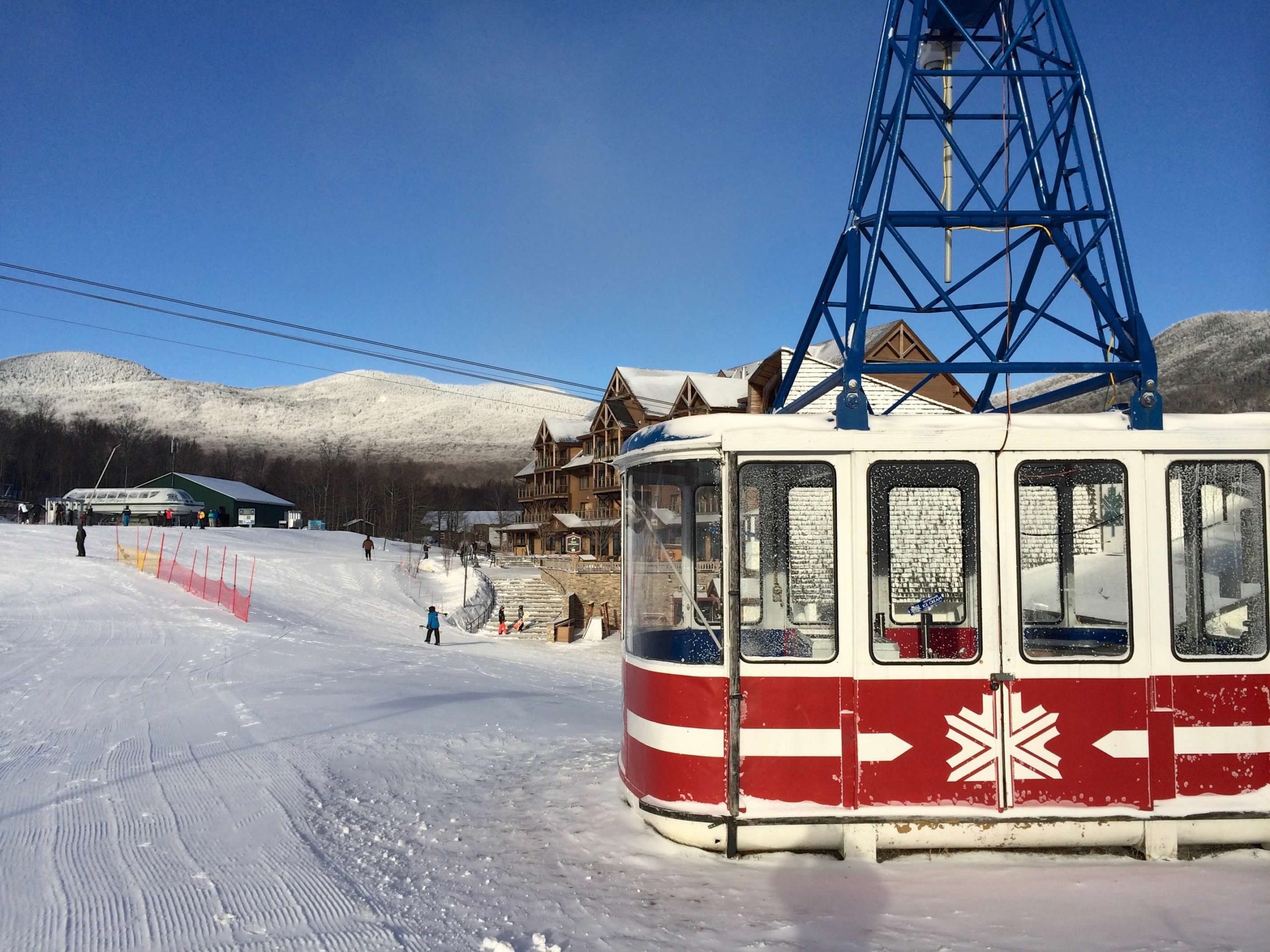 A red and white gondola rests on the grounds of Jay Peak in Vermont, one of the best ski resorts in the United States for families.