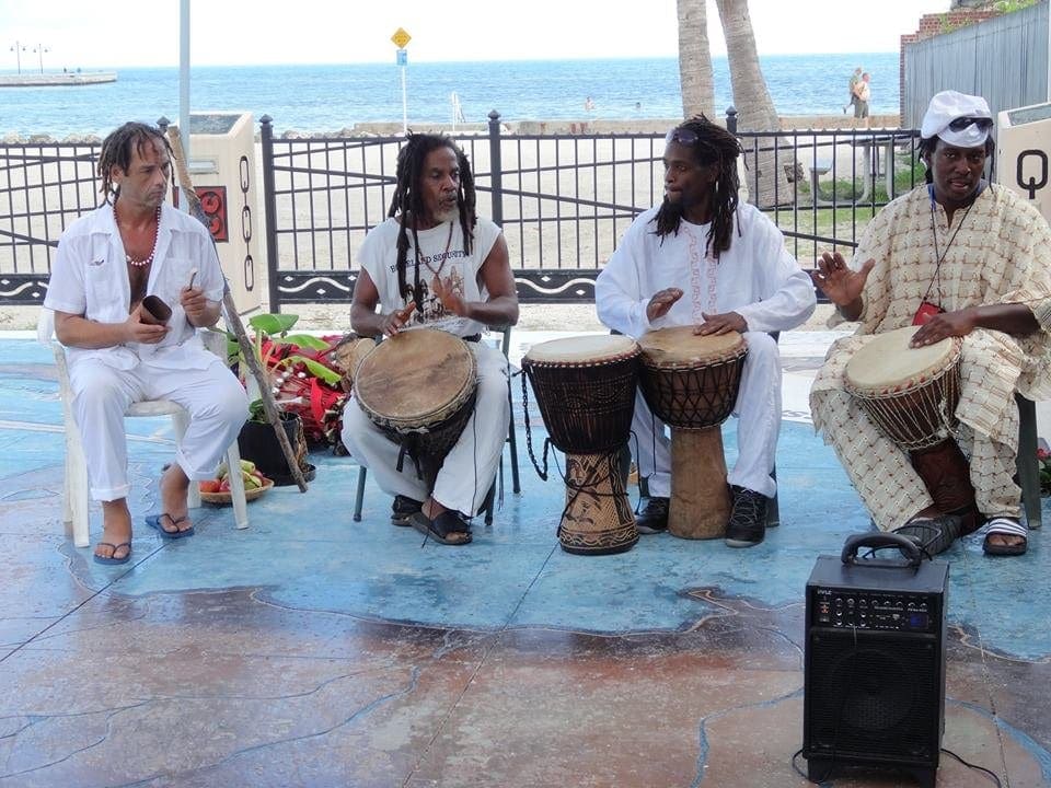 Several African American drummers and singers preform at Higgs Beach.
