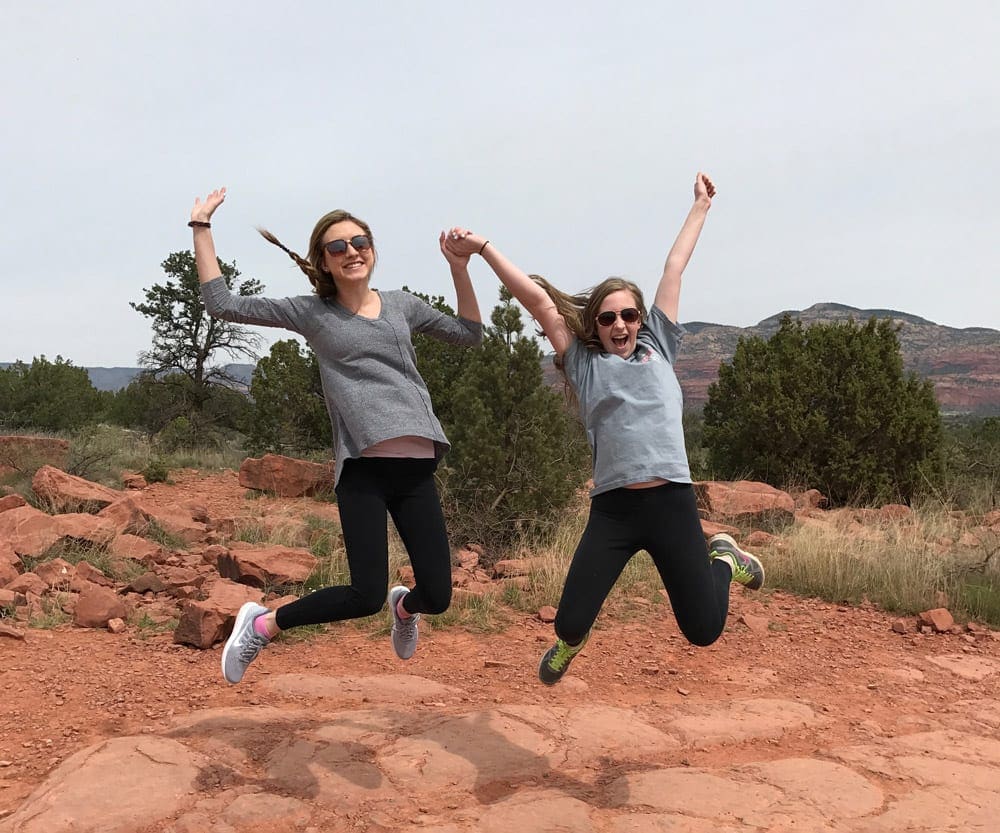 Two girls jump with joy in Arizona while on an Adventures by Disney tour.