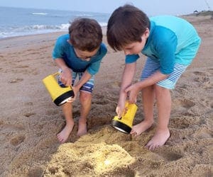 Two Boys looking for treasure in beach in Outer Banks NC