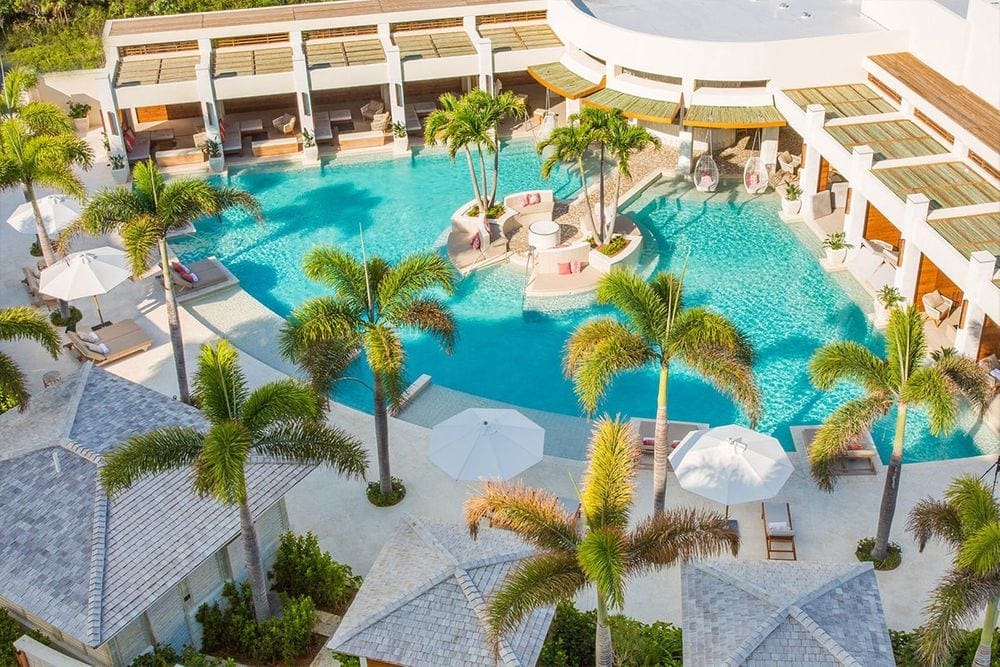 An ariel view of The Shore Club, featuring palms and a clear, turquoise pool.