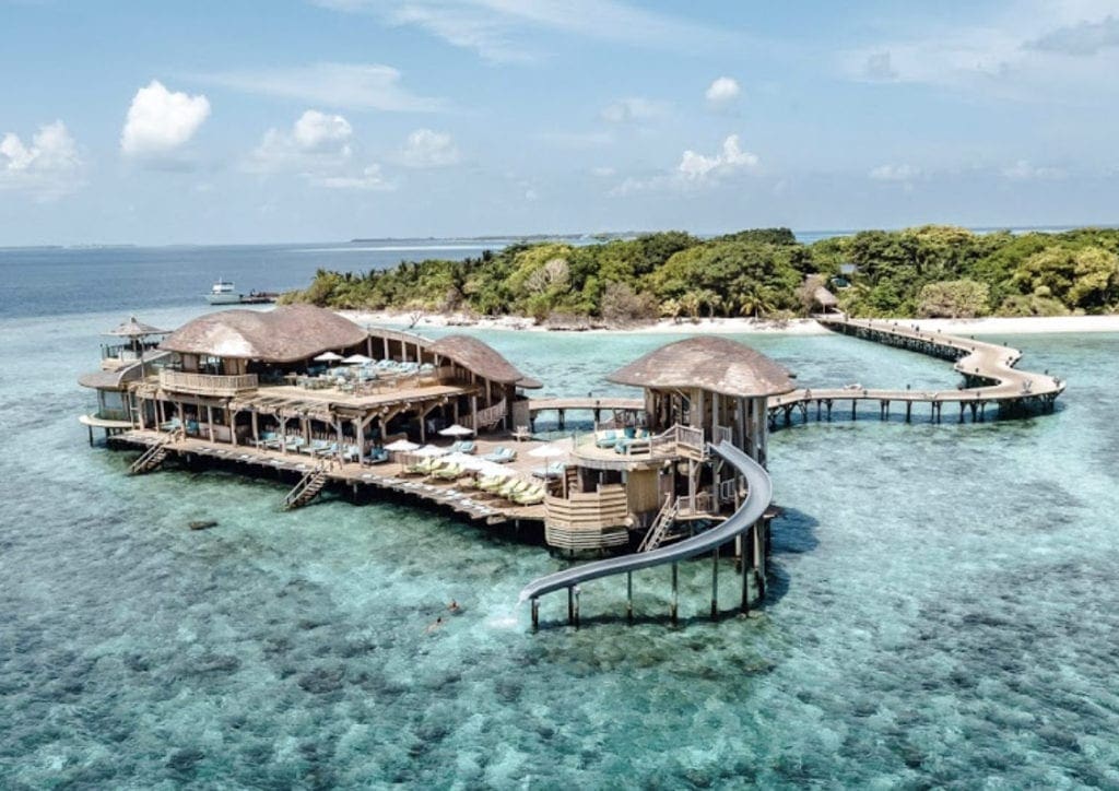 The main building at Soneva Jani, ones of the best Maldives hotels with slides for kids, with a slide extending into the ocean.