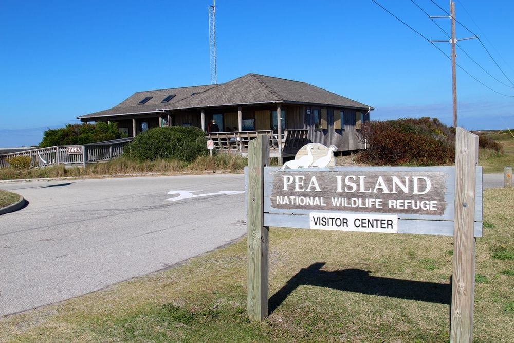 The visitor center and entry sign for the Pea Island National Wildlife Refuge, one of the best things to do on a Family Beach Vacation in the Outer Banks.
