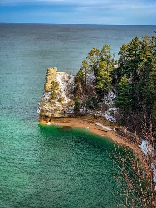 Miners Castle, a stunning Michigan rock formation, stands proudly surrounded by Lake Michigan.