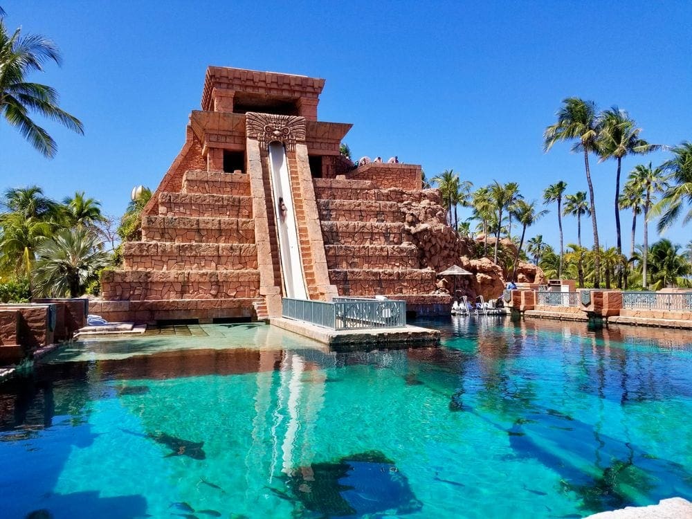 A large slide stretches into a pool at Atlantis Bahamas, one of the best hotels in the Caribbean with a water park for families.