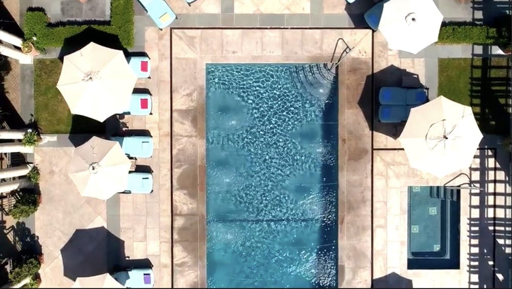 An aerial view of the pool and pool chairs at Glenmere Mansion, one of the best locations for a romantic getaway in the Northeast.