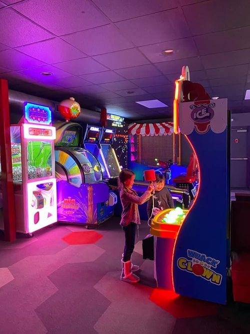 Two kids play at the arcade at Rocking Horse Ranch Resort.
