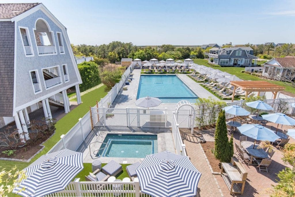 An aerial view of the large pool and jacuzzi at the Winnetu Oceanside Resort, one of the best resorts for a Family Vacation in Martha's Vineyard.