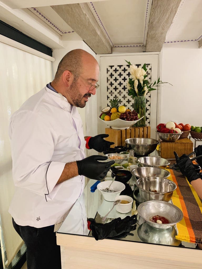 A chef explains the process of making a Colombian dish while teaching a cooking class in Cartagena.