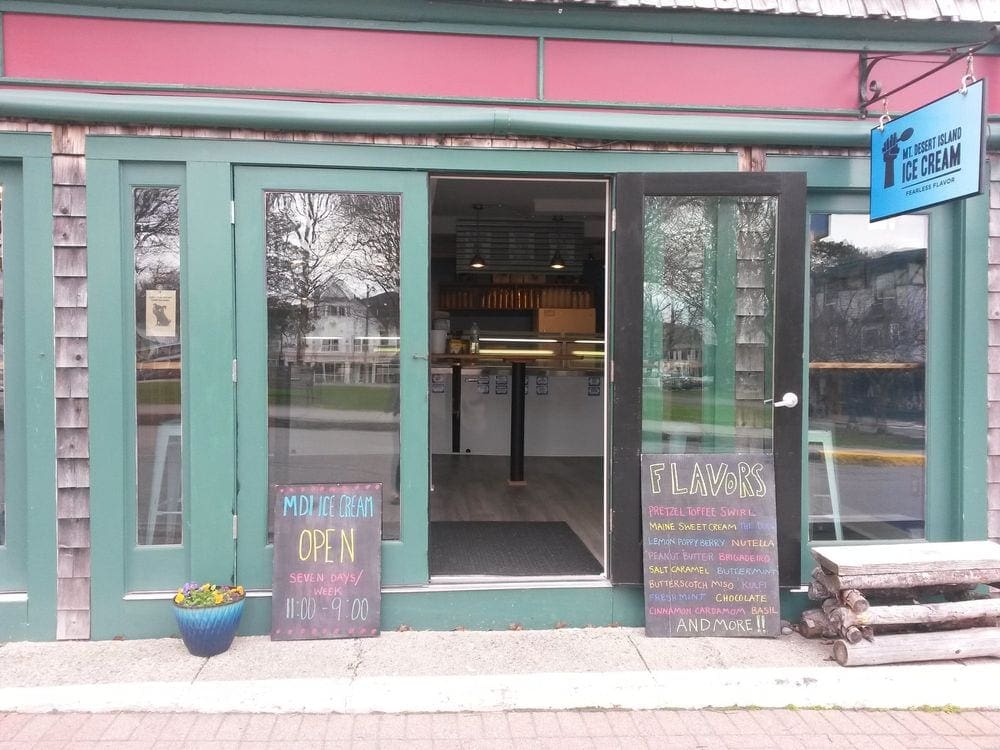 The colorful entrance for Mount Desert Island Ice Cream, featuring chalkboard signs displaying the daily specials.