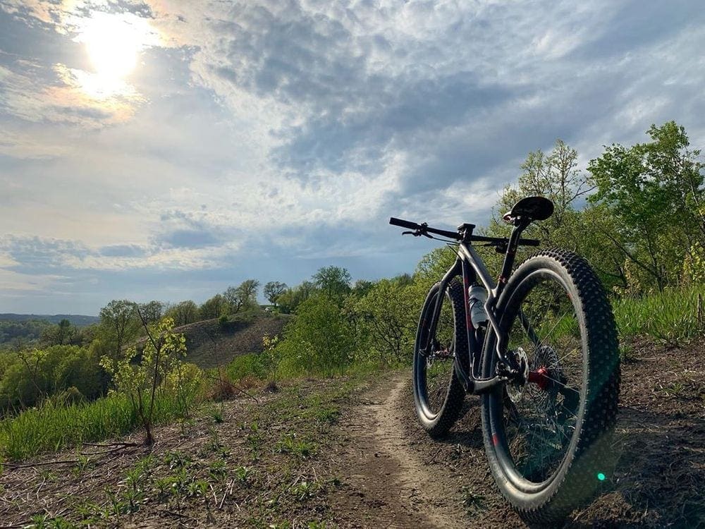 A riderless bike rests on a trail with a scenic overlook near Red Wing, Minnesota, one of the best weekend getaways from Minneapolis for families.
