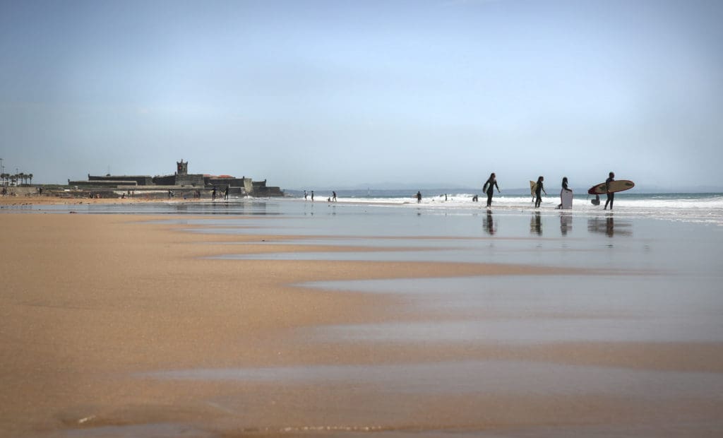 A landscape image of Carcavelos Beach near Lisbon, Portugal, one of the best places to visit as a family. 