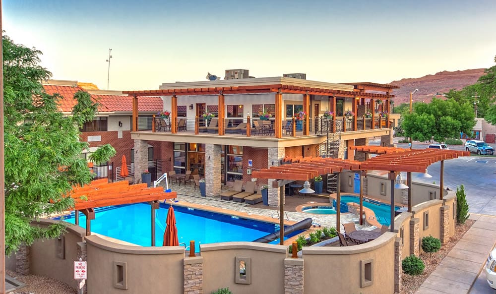 A view of the outdoor pool and hotel buildings at the Best Western Plus Canyonlands Inn, one of the options for hotels in Moab for families.