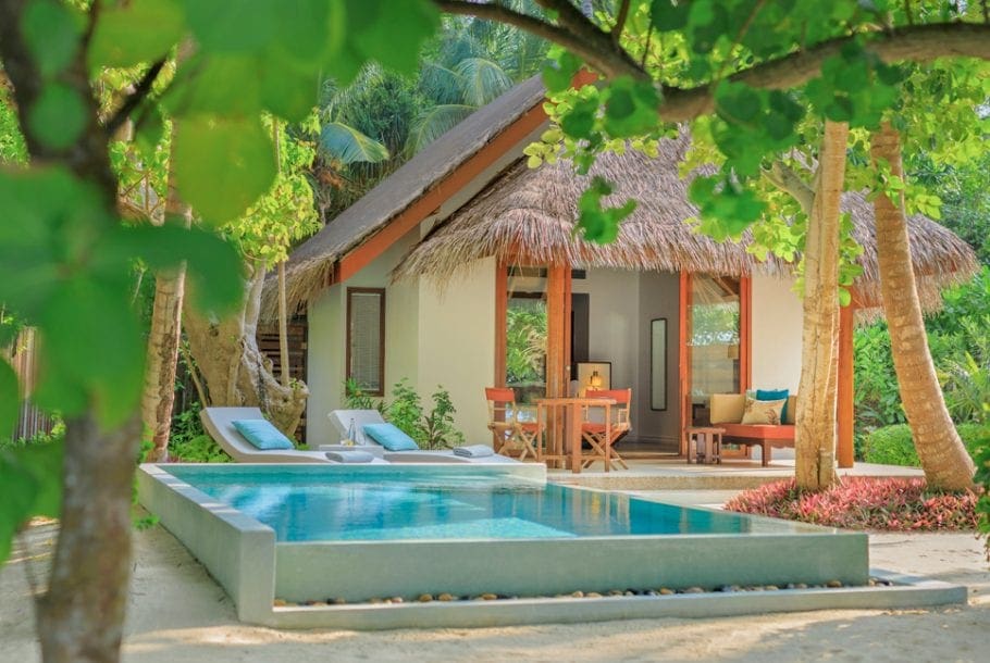 A close up of one of the bungalows at the Dusit Thani Maldives with a private pool and outdoor patio.