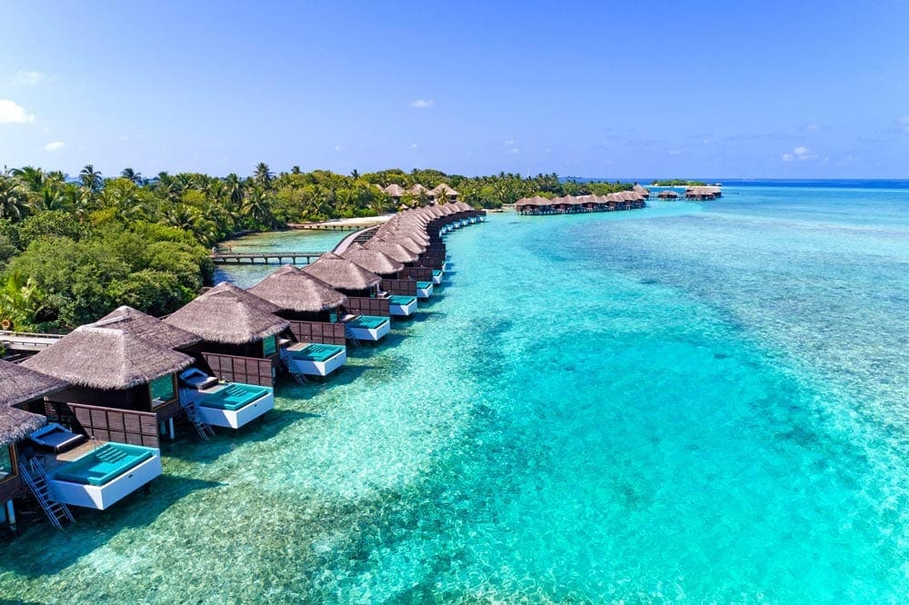 A view of the over-water bungalows at the Sheraton Maldives Full Moon Resort, one of the best family hotels in the Maldives.