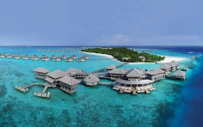A view of the Six Senses Laamu, featuring several over-water bungalows.