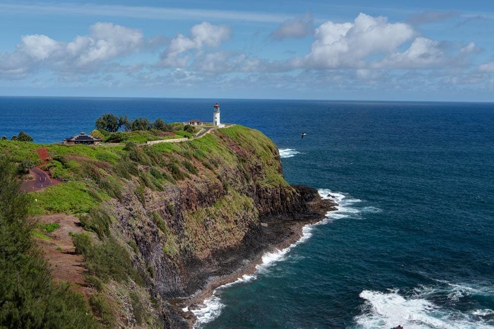 The Kilauea Lighthouse sits at the edge of a cliff that juts into the ocean in Kauai.