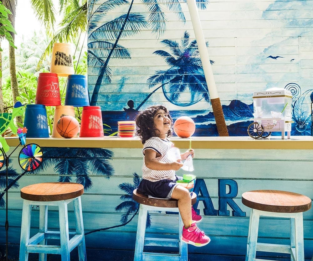 A young girl enjoys cotton candy at the One & Only Reethi Rah.