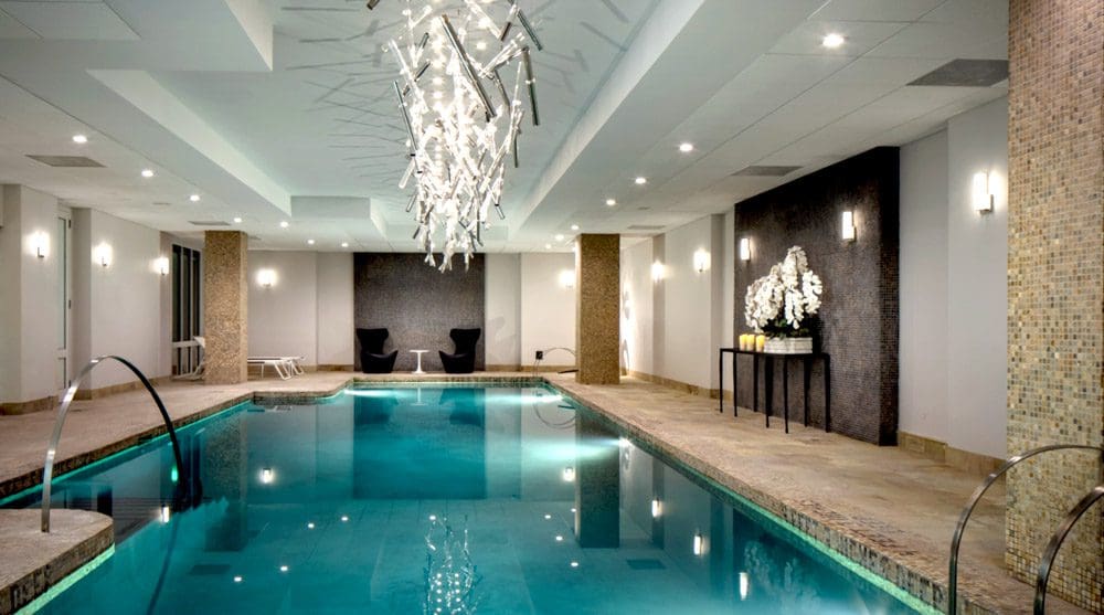 The indoor pool, with large crystal chandalier overhead, at the AKA Sutton Place.