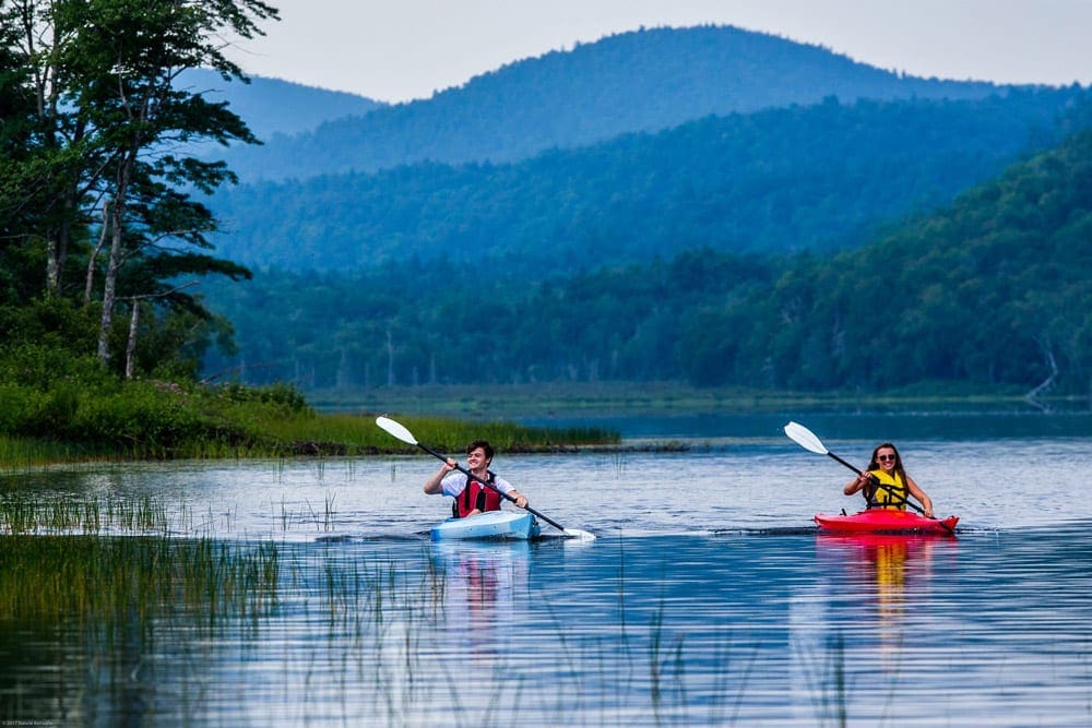 Two kayakers enjoy a pleasent morning on the water while staying at the Garnet Hill Lodge.