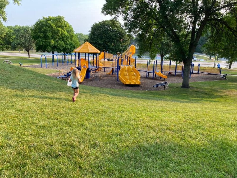 A young girl runs toward a colorful playground in Hastings, Minnesota.