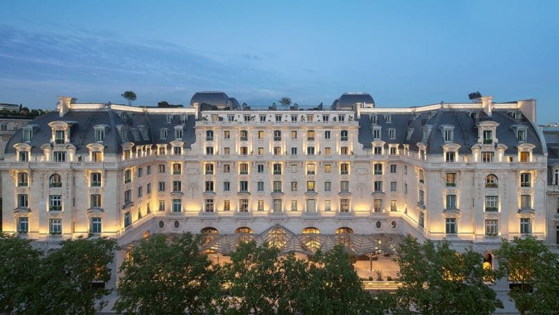 An aerial view of the The Peninsula Paris, well lit on a lovely evening.