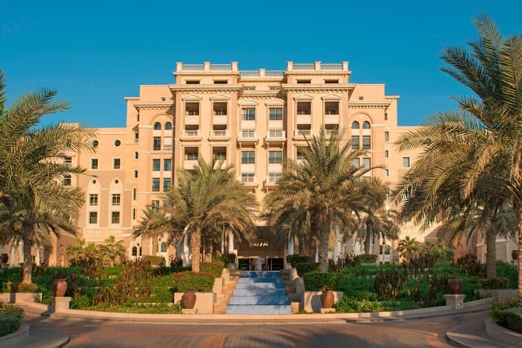 The entrance to the The Westin Dubai Mina Seyahi Beach Resort & Marina, with swaying palms in the front of the building, one of the best family hotels in Dubai.