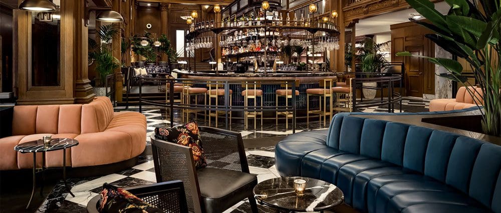 Inside the lobby and bar area of the Fairmont Olympic Hotel, Seattle, featuring masculine colors and finishes of blues and browns. 
