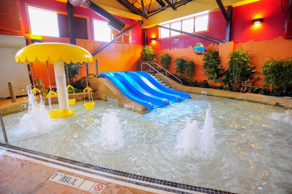 A small splash area for toddlers at the Kahuna Laguna at Red Jacket Mountain View, featuring a small splash area and low slide.
