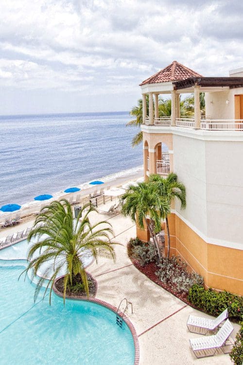A view of a resort building and pool, overlooking the ocean at the Rincon Beach Resort.