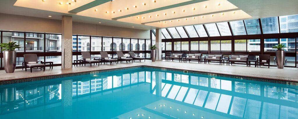 The large pool and pool deck, featuring expansive floor to ceiling windows on two sides, at The Westin Seattle.