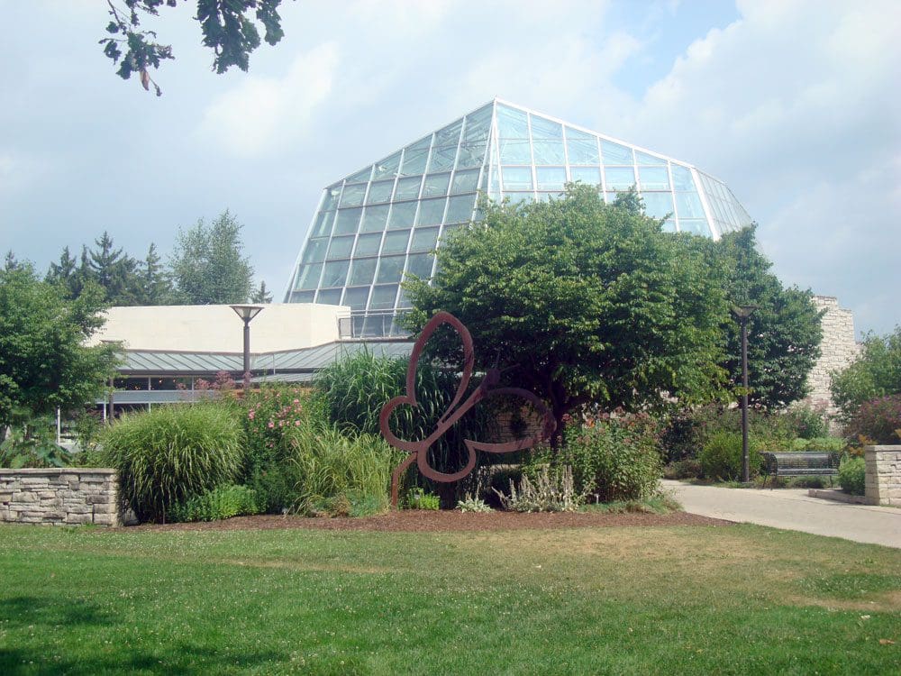A view of the Niagara Parks Butterfly Conservatory, including the iconic purple butterfly art installation on the grounds.