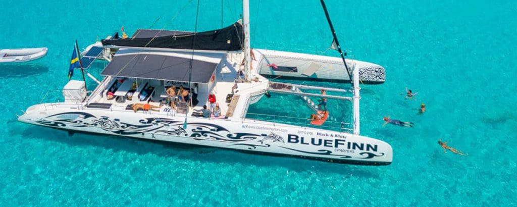 Several people enjoy a fishing tour with BlueFinn Charters Curacao.