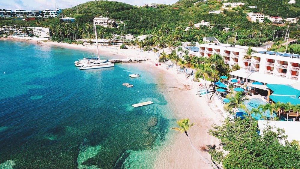 An aerial view of the resort grounds and beach at Bolongo Bay Beach Resort, one of the best US Virgin Islands resorts for families.