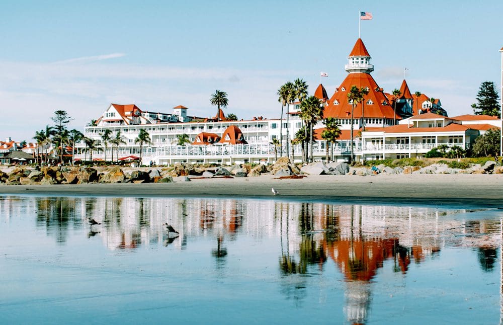 A view of the Hotel Del Coronado, Curio Collection By Hilton, across the water on a sunny day, a great stay when looking for one of the best US cities for a Memorial Day Weekend with kids.