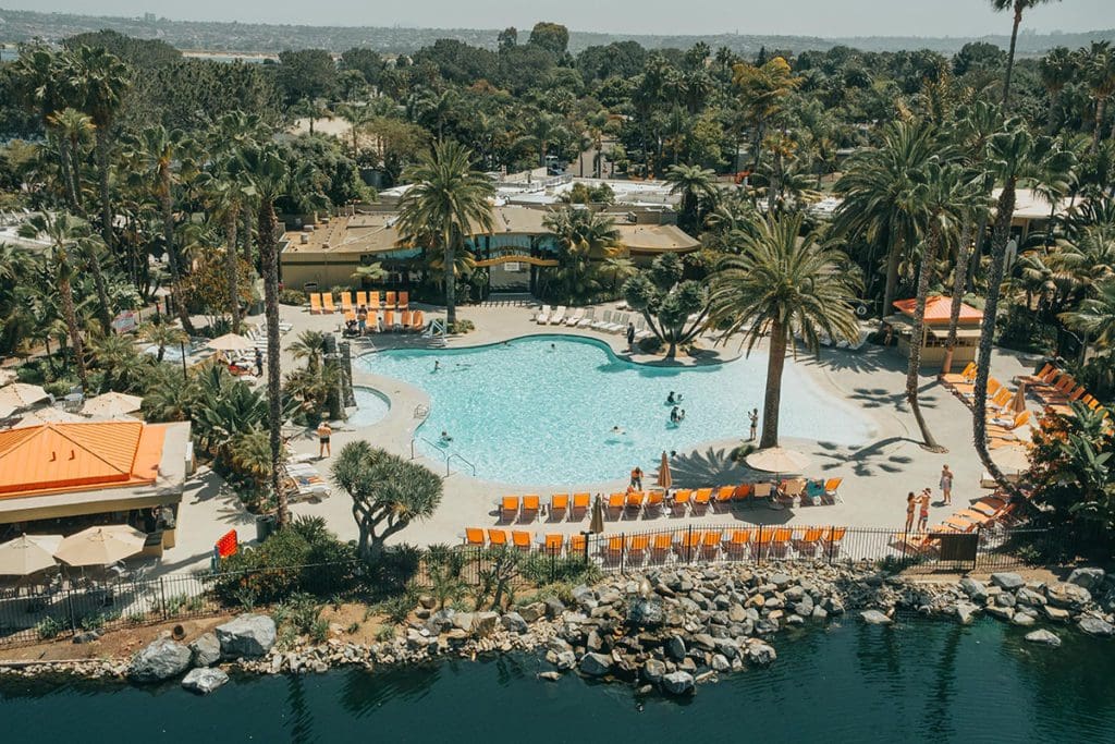 An aerial view of the pool and waterfront access at the Paradise Point Resort & Spa, one of the best San Diego beachfront hotels for families.