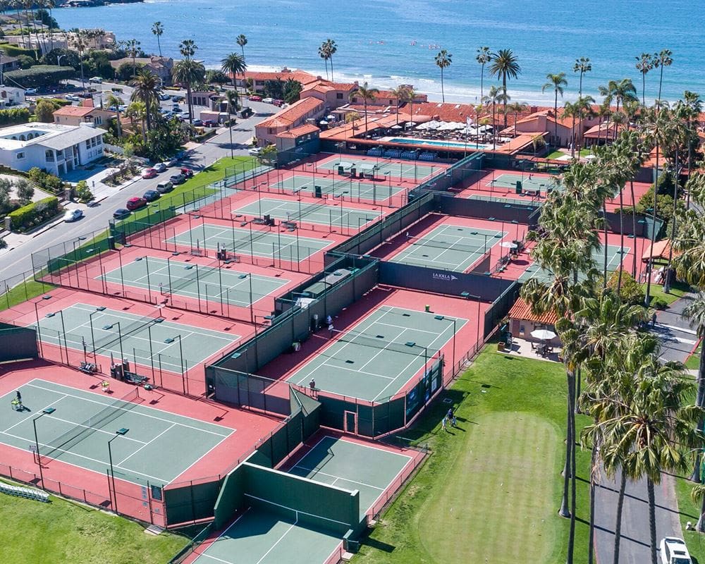 Several tennis courts lay empty on a sunny day at the La Jolla Beach and Tennis Club.