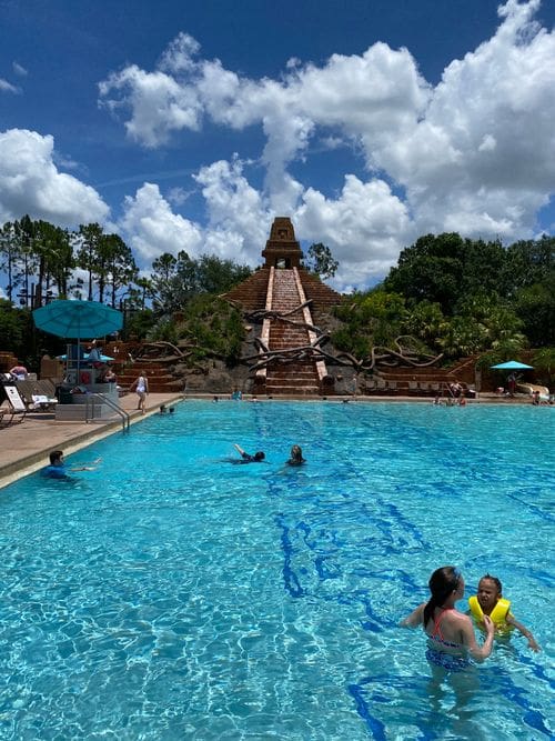 Several people swimming in the themed-pool at Disney's Coronado Resort.
