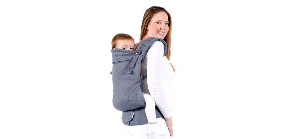 A mom holds her child on her back using a carrier by Beco Toddler Carrier.