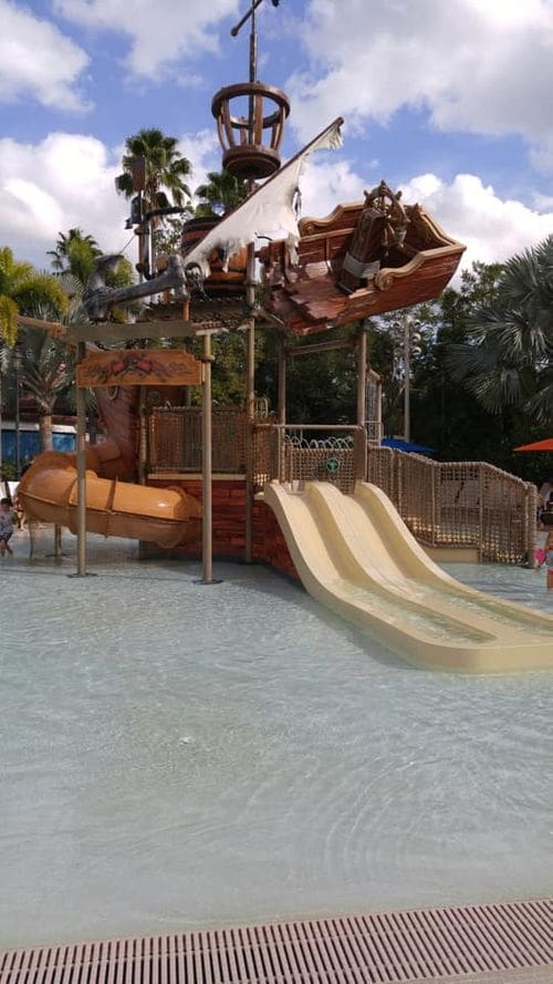 The pirate splash pad area at Disney's Caribbean Resort, featuring slides and a Pirate theme.