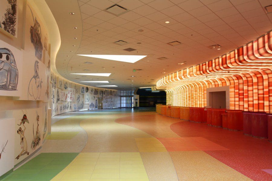 Down a long hallway at the Disney’s Art of Animation Resort, featuring a variety of drawings and color.