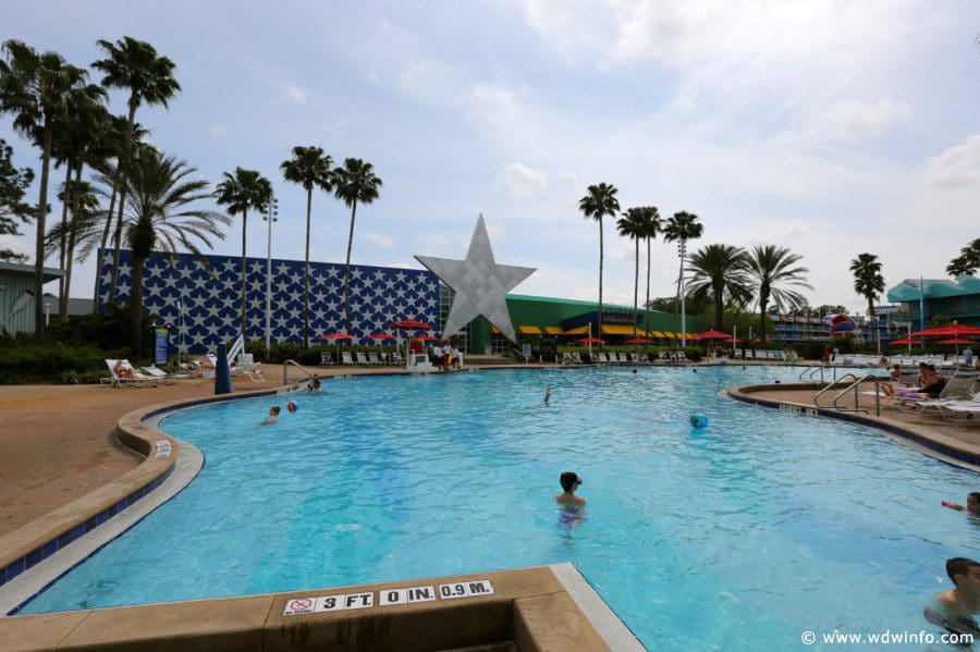 The pool at Disney's All-Star Sports Resort, with swaying palm trees behind it.