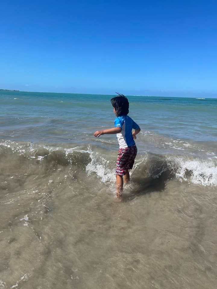A young boy wades in the ocean water off-shore from Puerto Rico.