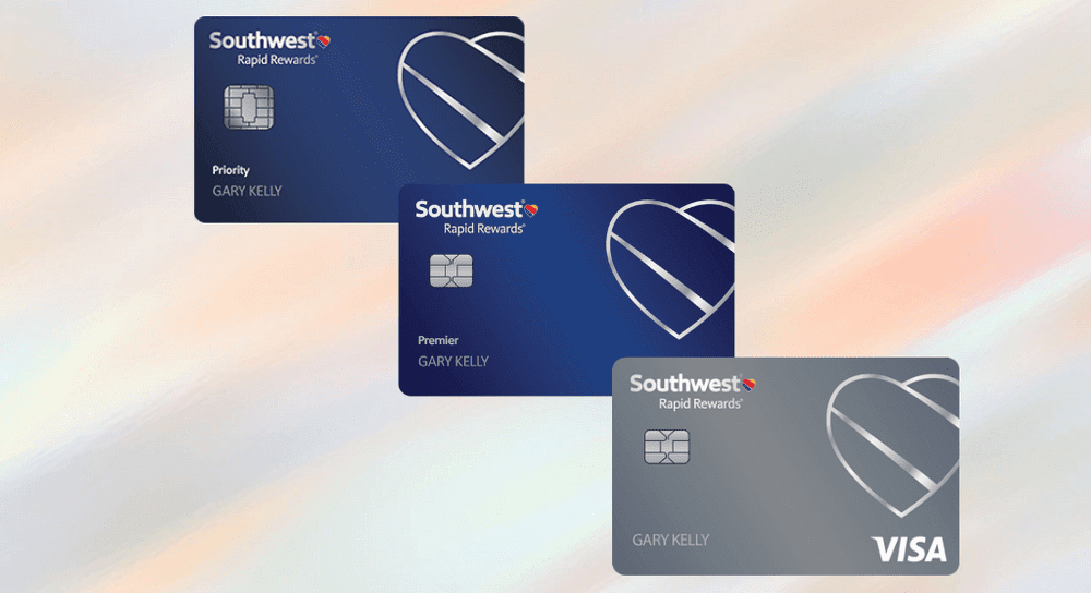 Three Southwest Rapid Rewards cards are stacked together, over a multi-hued graphic of pastels, personal cards available as part of the Southwest companion pass promotion.