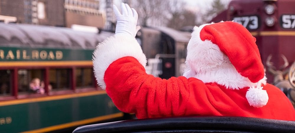Santa waves to children on a train car with the Conway Scenic Railroad.