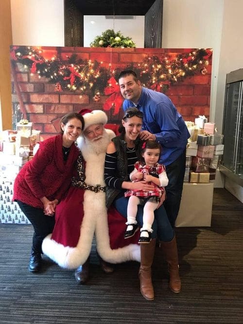 A family of four poses with Santa at the Macy's Christmas breakfast.